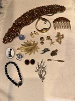 Full lot of vintage mixed costume jewelry arranged on cloth