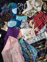 Full lot showing various vintage ladies scarves with a wide range of colors, patterns, and textures.