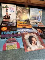 Photo shows 12 vintage vinyl LP albums from various artists including The Monkees, Burl Ives, Mantovani, The Bachelors, The Brothers Four, and others