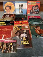 Photo of 13 vintage vinyl record albums with visible titles including The Partridge Family, Jamie Foxx, Perry Como, Percy Faith, Al Jolson, Mantovani among others.
