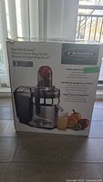 Photo of the Omega Mega Mouth Juicer box showing product name, 3-year warranty, images of juicer and fruit.