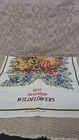 Towel showing West Australian wildflowers print with detailed botanical and floral design on white fabric.