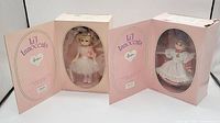 Two Effanbee Li'l Innocents dolls in their original pink boxes, displayed side by side with box doors open.