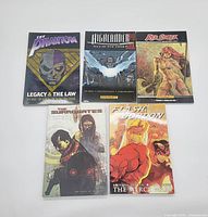 Five graphic novels arranged flat showing covers of The Phantom, Highlander III, Red Sonja, The Surrogates, and Flash Gordon.
