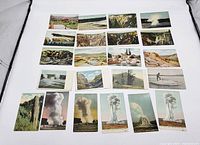 Collection of 25 vintage postcards laid out showing scenic views, waterfalls, canyon, and geysers from Yellowstone National Park.
