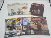 Seven Dragon Magazine issues fanned out showing a variety of cover art including fantasy themes and characters.