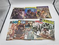 Photo showing three Epic Illustrated magazines with fantasy artwork on covers, and five The Savage Sword of Conan magazines with illustrated Conan the Barbarian covers, showing the lot's vintage comic/fantasy magazines.