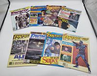 Photo shows all 8 issues of Fantastic Films magazines laid out on fabric background with visible colorful sci-fi themed covers including Superman, Lord of the Rings, Battlestar Galactica, Star Trek.