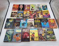 Overview photo showing all 25 vintage science fiction paperback books arranged in rows, clear view of covers.