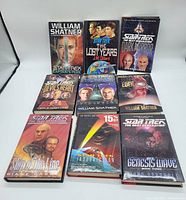 Ten hardcover Star Trek books arranged in rows, showing titles and cover art, on white background.