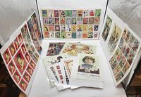Wide view of several laminated Victorian advertising reproduction sheets displayed upright showing many colorful vintage labels, ads, and a baking powder illustration.