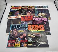 Overview of vintage science fiction magazines including titles: Starlog, Analog, Future, Space Wars, and Star Encounters. Covers feature images of Star Wars characters and sci-fi themes.