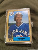 Single baseball card showing Manny Lee in Toronto Blue Jays uniform with Topps logo.