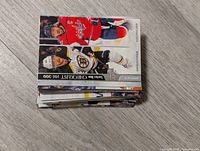 Stack of hockey cards showing top cards including Washington Capitals player Alex Ovechkin and Boston Bruins player Patrice Bergeron, part of Select and Checklist series.