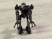 Front angled view of the complete Toa Onua LEGO Bionicle figure showing articulated limbs, claw hands, and mask detail.