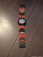 Full length of LEGO Star Wars watch showing the black and red interlocking brick style band.