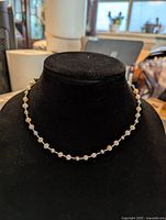 Full view of the pearl bead necklace displayed on a black velvet bust showing spacing and style.