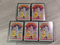 Five unopened 1985 Donruss Lou Gehrig Diamond King themed baseball cards in original shrink wrap showing front cover featuring Lou Gehrig in a swinging position with red and yellow accents.