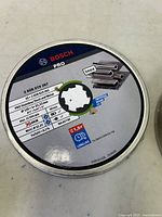 Top view of a Bosch Pro cutting wheel canister with full label showing specifications and X-LOCK mounting system.