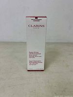 Front and side views of the Clarins Supra Serum Multi-Intensive box showing product name, uses and volume.