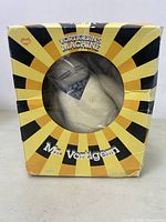 Front view of original box with visible figure inside through clear plastic window.