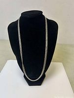 Front view of the sterling silver men's chain necklace displayed on a black bust stand, showing full length and design.