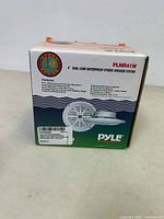 Box front showing Pyle PLMR41W dual cone waterproof stereo speaker system and features.