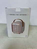 Front box view of QT3 portable air purifier showing product image and key features: Portable, Fan, Air Purifier.