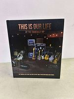 Photo of book cover with the title and band equipment setup image.