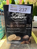 Front view of one box showing brand, flavor, and quantity of bisquettes.