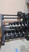 Dumbbell bench, rack and assortment of dumbbells on two tiers