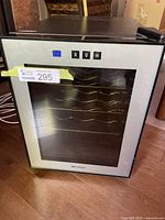 Front view of Emerson wine fridge showing stainless steel framed glass door and internal wine racks with control panel above door.