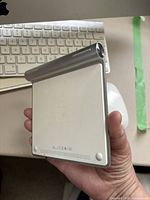 First-generation Apple Magic Trackpad showing underside and battery compartment