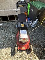 Front view of the red Toro SR4 Super Recycler gas lawn mower showing handle, mower deck, and attached collection bag.