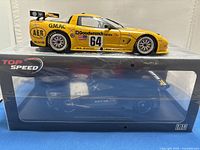 Side view of yellow diecast model in display case