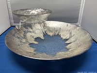 Large glass chip bowl shown flat with silver textured accent design radiating from center