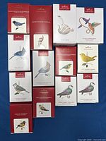 Overview of all twelve boxed ornaments laid out on blue background