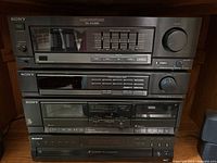 Front view of Sony audio system with amplifier, tuner, cassette deck, and CD changer stacked vertically.