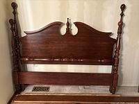 Front view of the traditional queen size headboard and footboard showing detailed turned posts and finials with polished cherry finish.