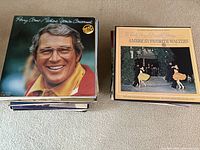 Stack of vinyl records with Perry Como's album on top alongside a separate stack with "America's Favorite Waltzes" album visible.