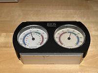 Close-up of the BIOS thermometer and hygrometer device showing temperature and humidity dials