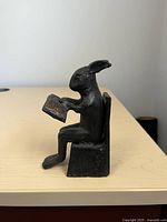 Front left side view of the cast iron rabbit door stopper on a table