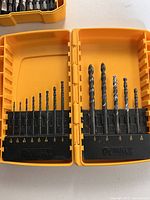 Yellow DeWalt plastic case open showing assorted twist drill bits in varying sizes