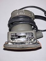 Porter Cable Model 340 electric sander front showing label and power cord wrapped around the tool