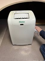 Front view of Hisense portable air conditioner unit, showing air vent and control panel on top.