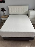 Full view of assembled mattress and boxspring on floor