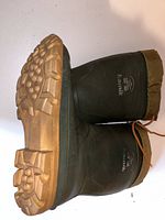 Side view of one boot showing Kamik branding and sole tread detail