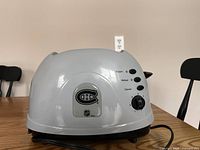 Photo of white Pro Toaster with Montreal Canadiens logo on side, showing control buttons and dial.
