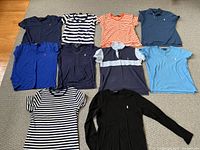 Overview photo showing all 10 Polo Ralph Lauren shirts in various colours and sizes, laid flat on the floor.