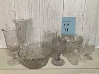 Photo showing 10 assorted vintage glassware pieces including bowls, goblets, and vases with different patterns and shapes